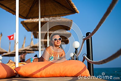 Girl lying on the pier. Attractive young woman in swimsuit lying on the pier. woman in swimsuit lying on the wooden pier on the Stock Photo