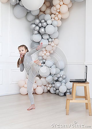 Girl makes online dance lessons. Stock Photo