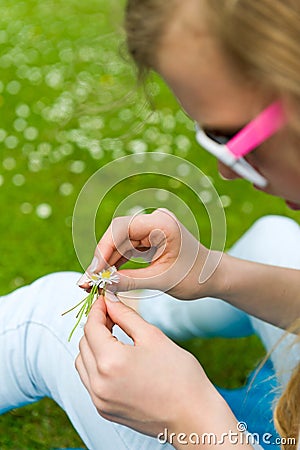 Girl making a daisy chain Stock Photo