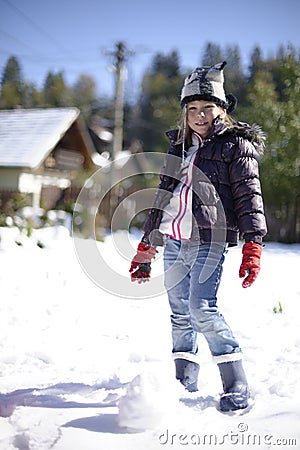 Girl making snowballs Stock Photo