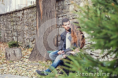 Girl man couple sitting autumn park Stock Photo