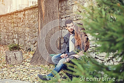 Girl man couple sitting autumn park Stock Photo