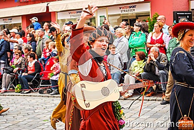 Girl in medieval costume waves to the crowds Editorial Stock Photo