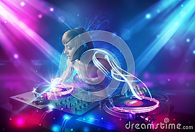 girl mixing music with powerful light effects Stock Photo