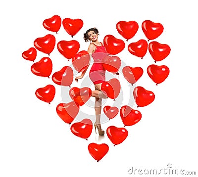 Girl model in a heart made of balloons. Beautiful woman with the symbol of Valentine`s Day. Red Valentine on a white background Stock Photo