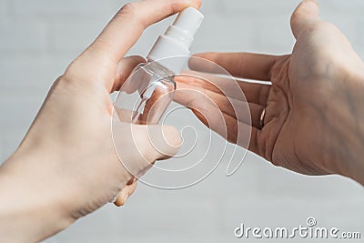 Girl moisturizes her dry hands. Dry hand treatment. Hand antiseptic as a defense against the virus Stock Photo