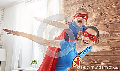 Girl and mom in Superhero costumes Stock Photo