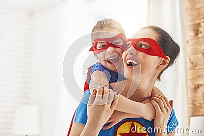 Girl and mom in Superhero costumes Stock Photo