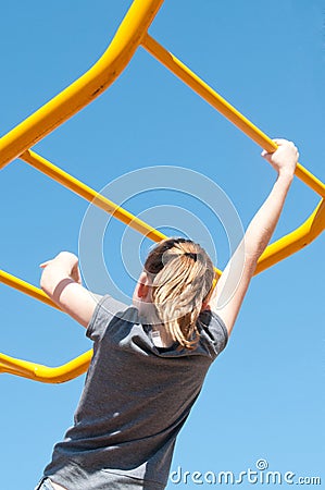 Girl on monkey bars Stock Photo