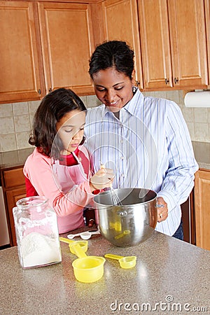 Girl And Mother Cooking Stock Photo