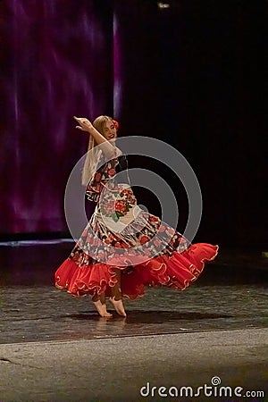 A girl in a national dress dances a gypsy dance Editorial Stock Photo