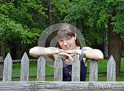 Girl near vintage rural fence Stock Photo