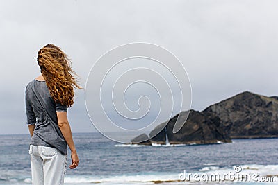 Girl and ocean volcanic island Portugal Azores Stock Photo