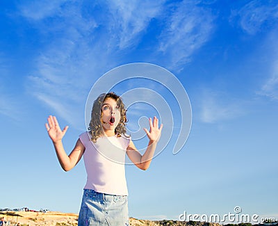 Girl open arms outdoor under blue sky Stock Photo