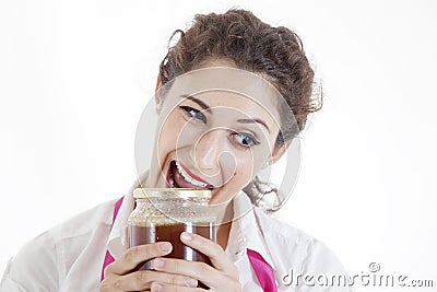 Girl opens a jar of honey with teeth Stock Photo