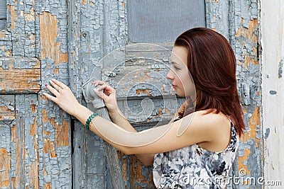 Girl opens a old door Stock Photo