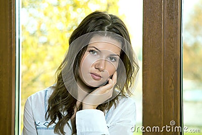 The girl opens a window in the autumn Stock Photo