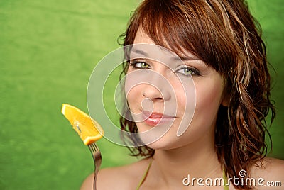Girl and orange on a fork Stock Photo