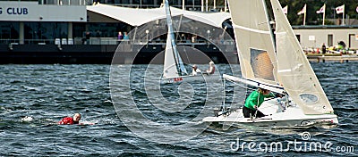 Girl overboard from racing dinghy. April 16, 2013: Editorial Editorial Stock Photo