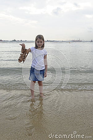 Girl paddling in the sea Stock Photo