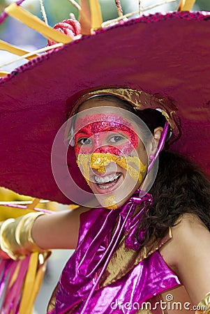 A girl with a painted face, wearing a large hat Editorial Stock Photo