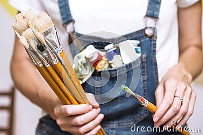 Girl painter holds a brush Stock Photo