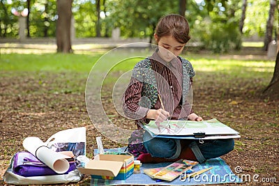 Girl painting on easel Stock Photo