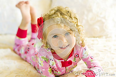 Girl in Pajamas On Bed Stock Photo