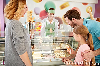 Girl with parents chooses flavors of ice cream Stock Photo