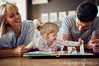 Girl with parents playing and eating banana Stock Photo