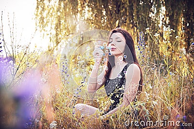 Girl park blowing bubbles Stock Photo