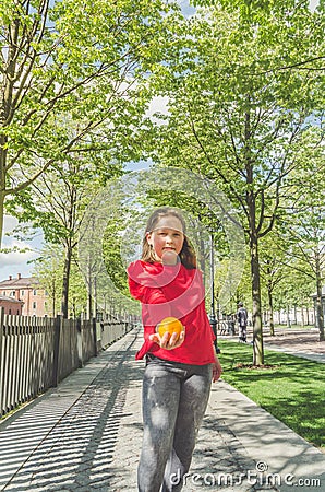 Girl in the Park with a delicious fragrant orange Stock Photo