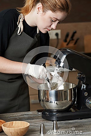 Girl pastry chef makes cream Stock Photo