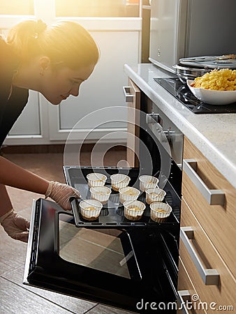 Girl pastry chef prepares muffins or cupcakes Stock Photo