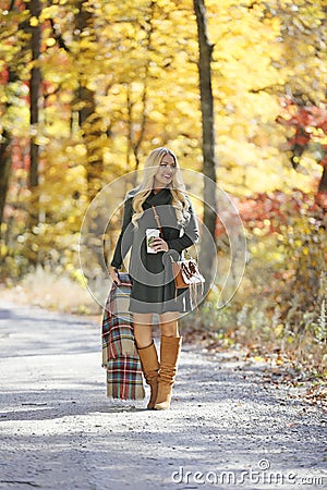 Girl on path through forest in fall Stock Photo