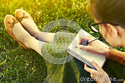 Girl with pen writing Stock Photo