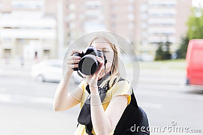 Girl photographer pictures of content on the streets of the city Stock Photo
