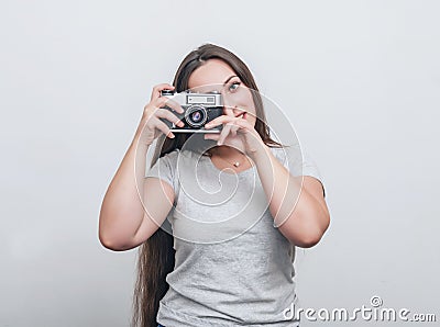 Girl photographer takes a photo with an old film camera Stock Photo