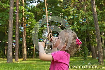 The girl in a pink blouse releases bubble Stock Photo