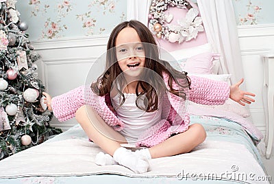 A girl in a pink knit cardigan in bed Stock Photo