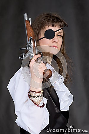 Girl - pirate with pistol in hand and eye patch Stock Photo