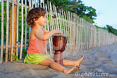 Girl play ethnic music on traditional african hand drum djembe Stock Photo