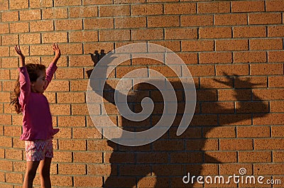 Girl play with her shadow Stock Photo