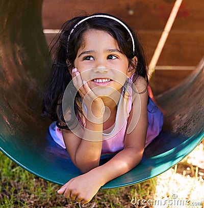 Girl, playground and thinking with fun, youth and child outdoor in a park with idea. Kid, smile and happy on school Stock Photo