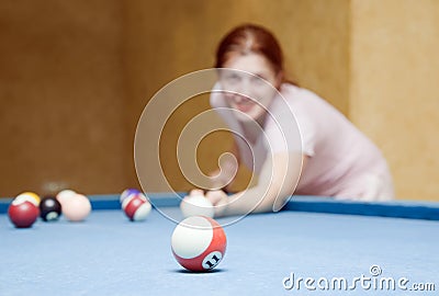 Girl playing billiards. Stock Photo