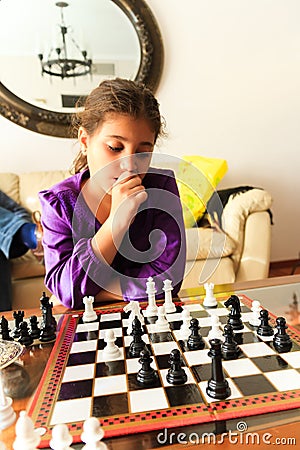 Girl playing chess Stock Photo