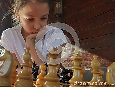 Girl playing chess Stock Photo