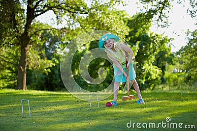 Girl playing croquet Stock Photo