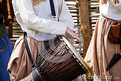 Girl playing on djembe drum Stock Photo