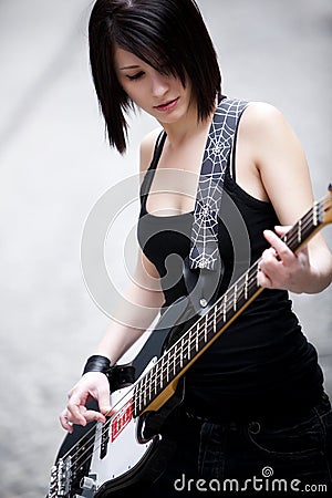 Girl playing electric bass Stock Photo